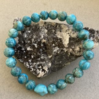 Браслет Південно- африканська бірюза, форма куля гладка з вставкою намистини.
Розмір намистини 9мм, розмір 17см обхвату.
Ціна за шт.